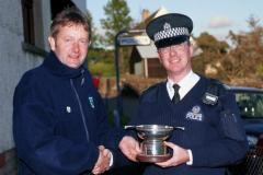 Iain Erskine receiving the trophy on behalf of Strathclyde Police from Neil Molyneux